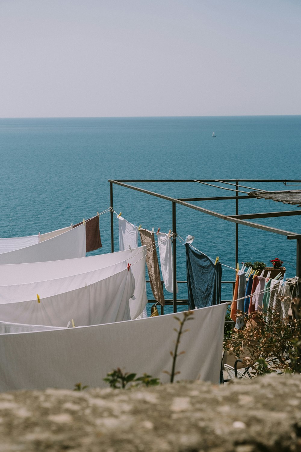 a white umbrella and a white tent on a rocky beach