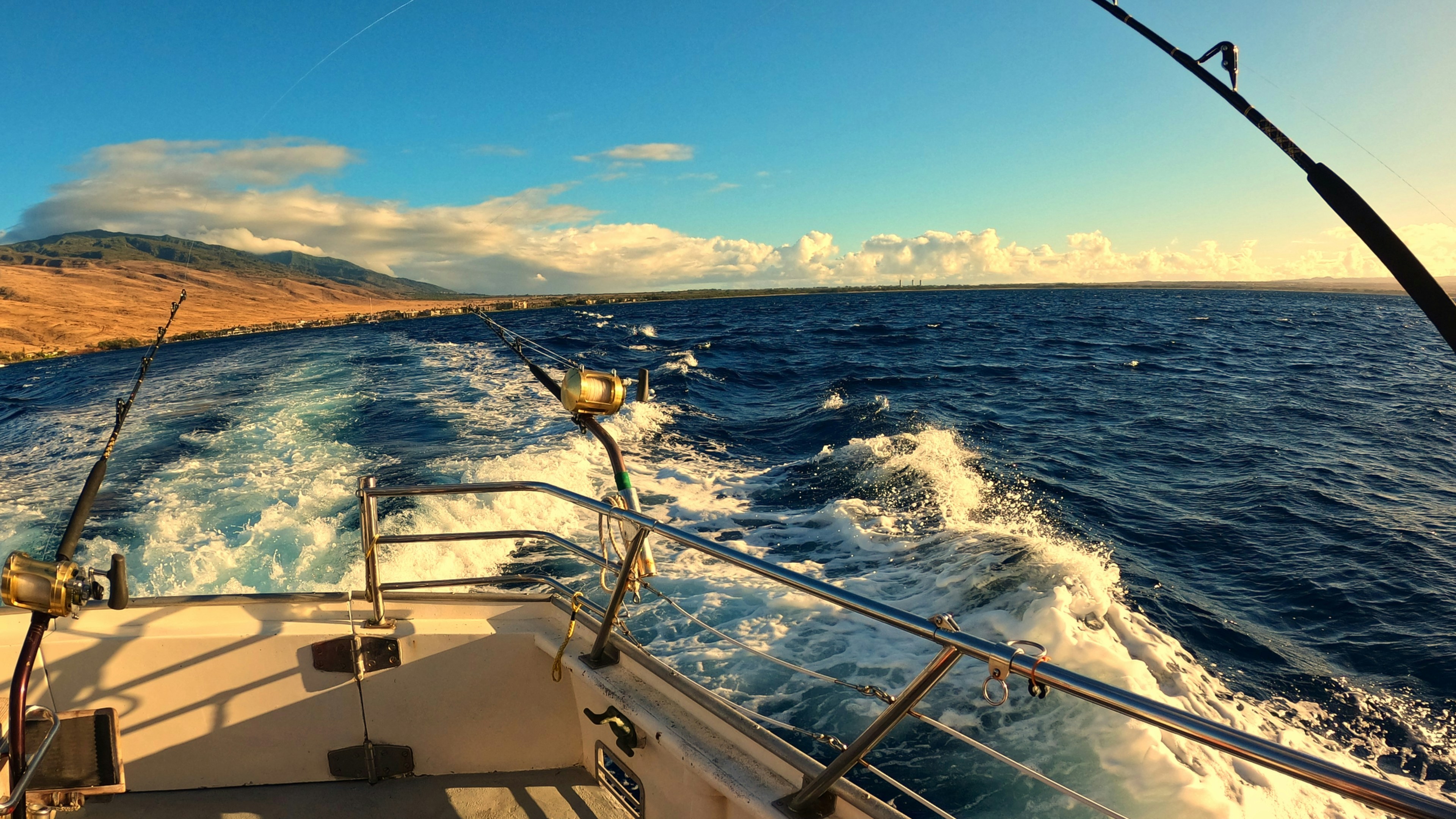 A private yacht charter sailing smoothly in the clear waters of Maui