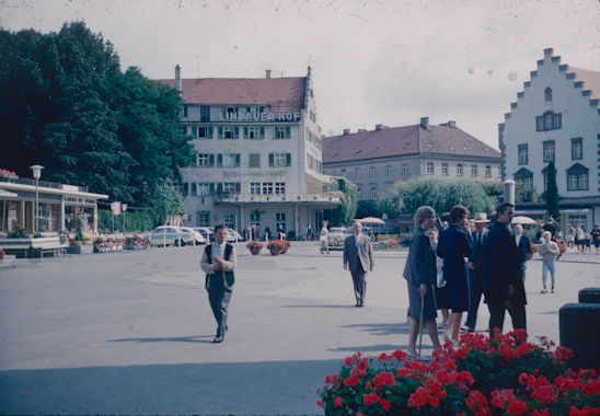 A diverse group of local professionals collaborating on a community development project in a vibrant European town.