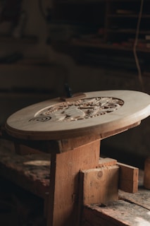 a wooden table with a metal object on top of it