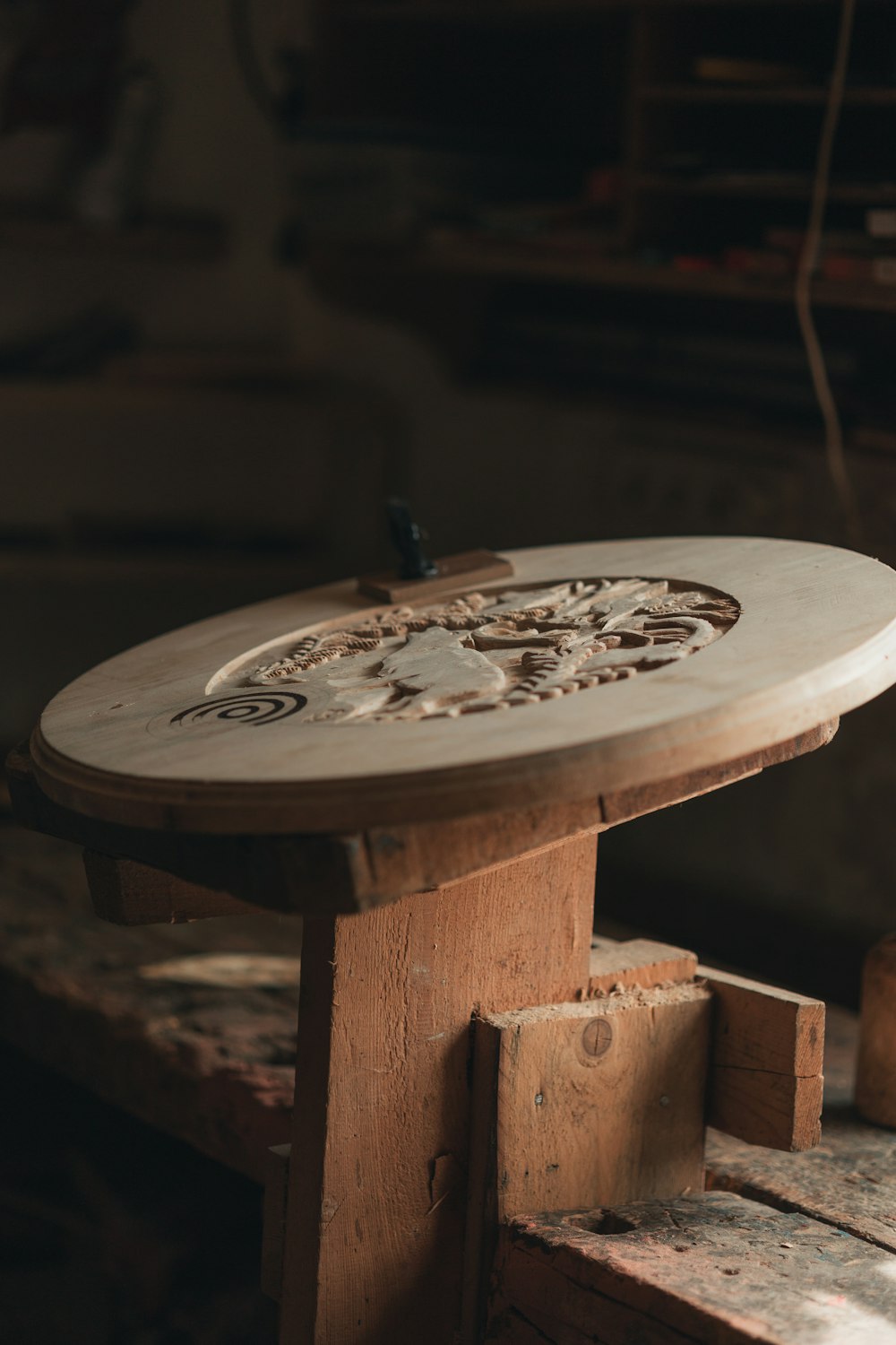 a wooden table with a metal object on top of it