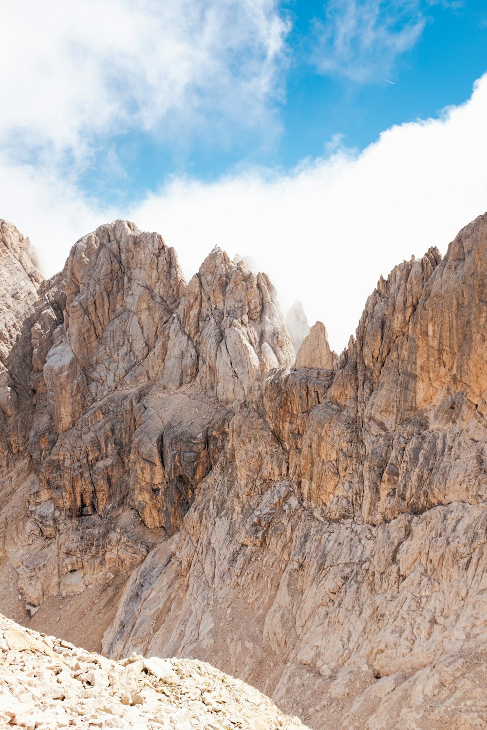 a rocky mountain with a blue sky