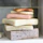 Close-up of pastel pistachio-colored soap bars stacked neatly with a soft pink background.