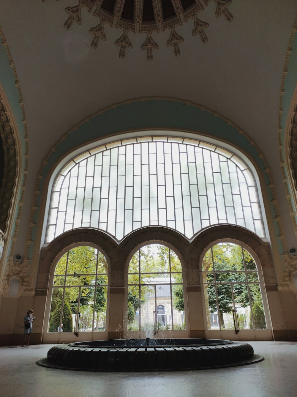 a large room with a large arched window and a large arched window