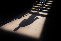 a person's shadow on a sidewalk