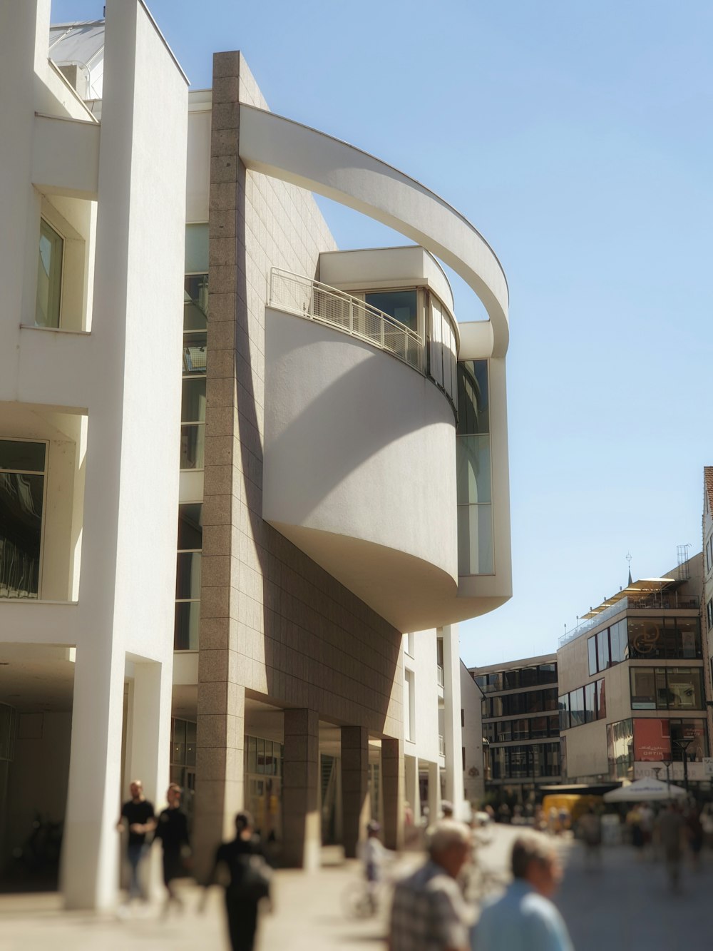 a group of people walking around a building