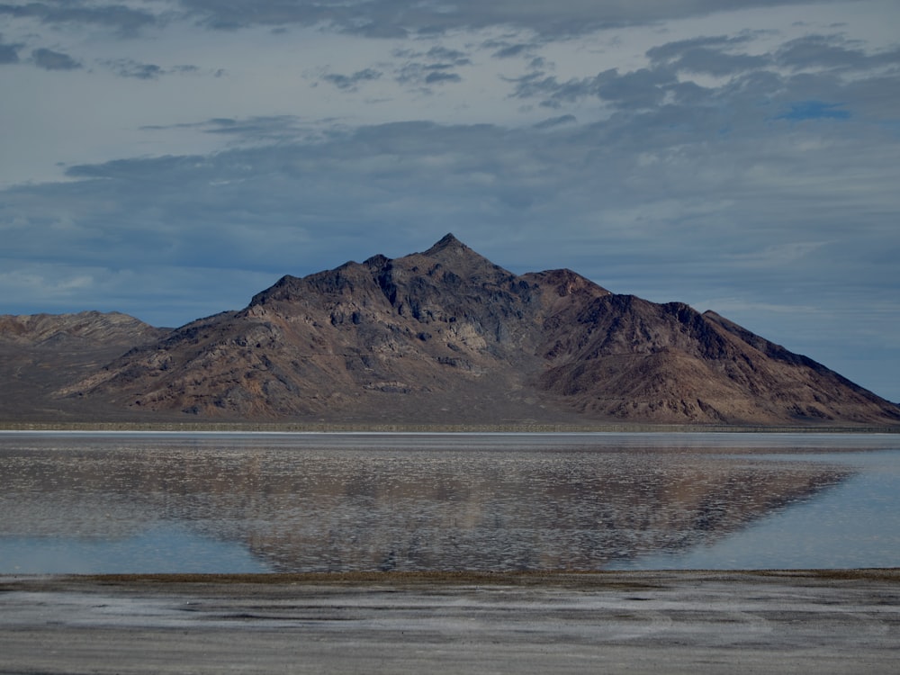 a body of water with a mountain in the background