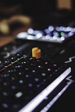a small orange toy on a keyboard