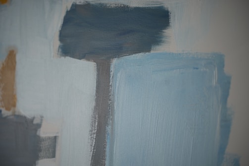 An abstract wall art piece featuring calming blue tones.