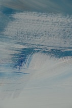 A close-up of a brushstroke on a canvas, showcasing the texture and colors of a nature-inspired painting.