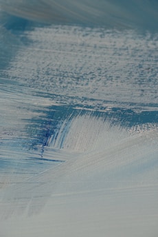 A close-up of a brushstroke on a canvas, showcasing the texture and colors of a nature-inspired painting.