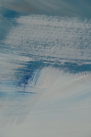 Close-up of textured acrylic brushstrokes revealing layers of earthy tones.