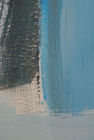 A close-up of a hand-painted abstract canvas showcasing soft colors and intricate textures.