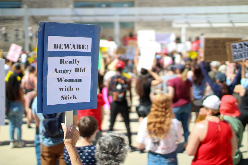 a crowd of people holding signs