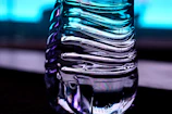 Close-up of a translucent plastic bottle being molded on an industrial machine