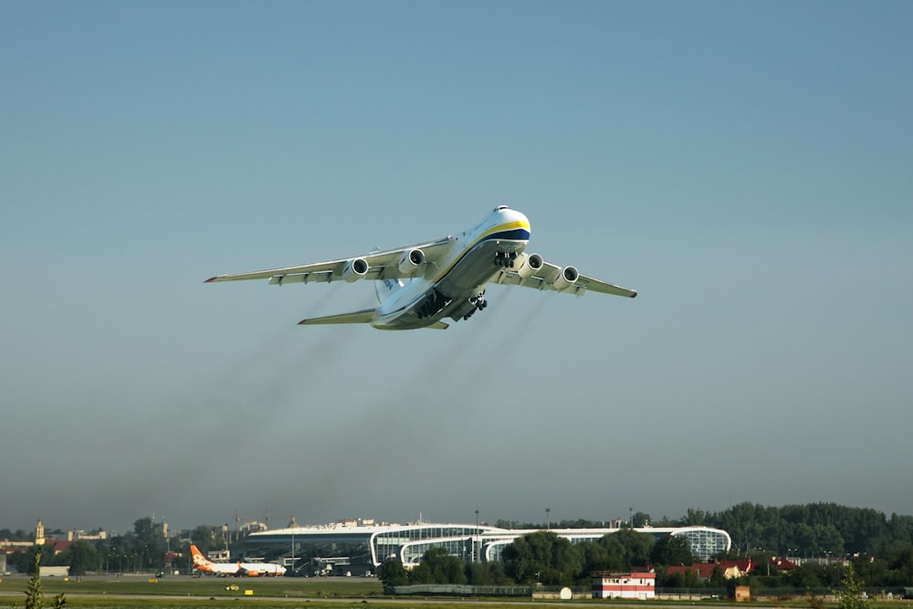 an airplane flying over a runway