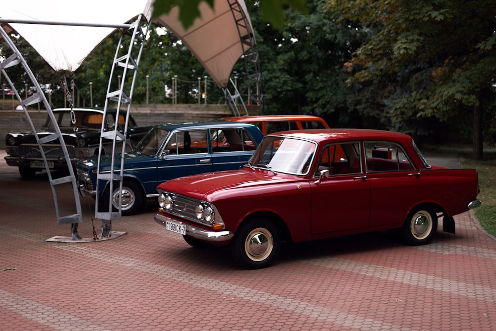 a red car parked next to a blue car