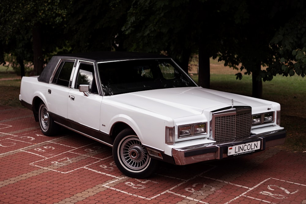 a white car parked on a brick road