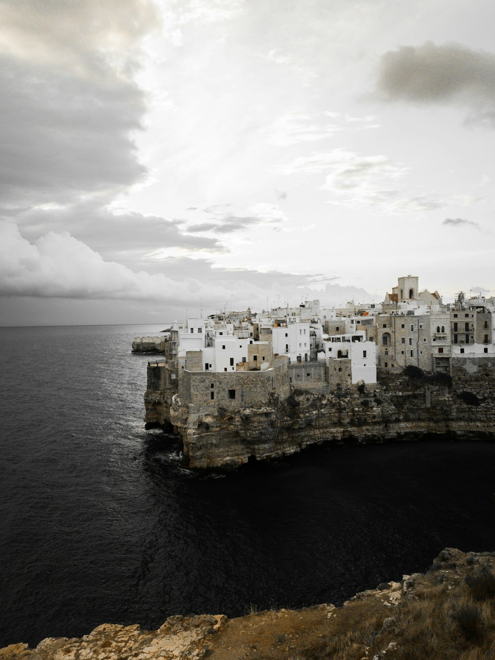 a city on a cliff by the water