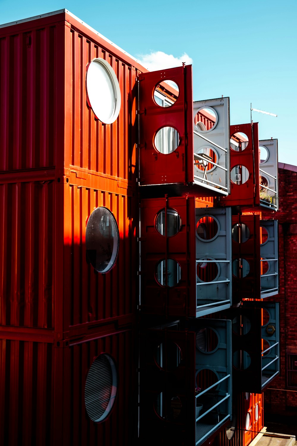 a row of red and white shipping containers