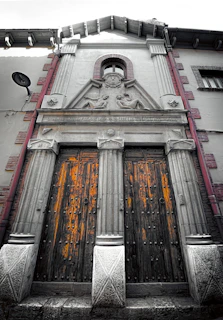Elegant facade of a colonial style house with wooden doors.