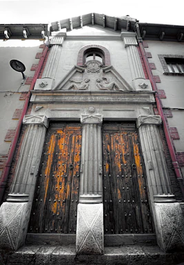 Elegant facade of a colonial style house with wooden doors.