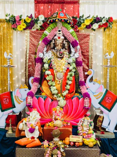 Devotees offering vibrant flowers and sacred items at the temple altar.