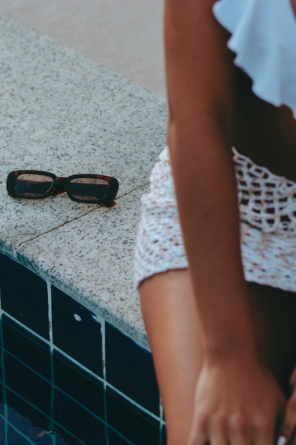 a person's legs and sunglasses