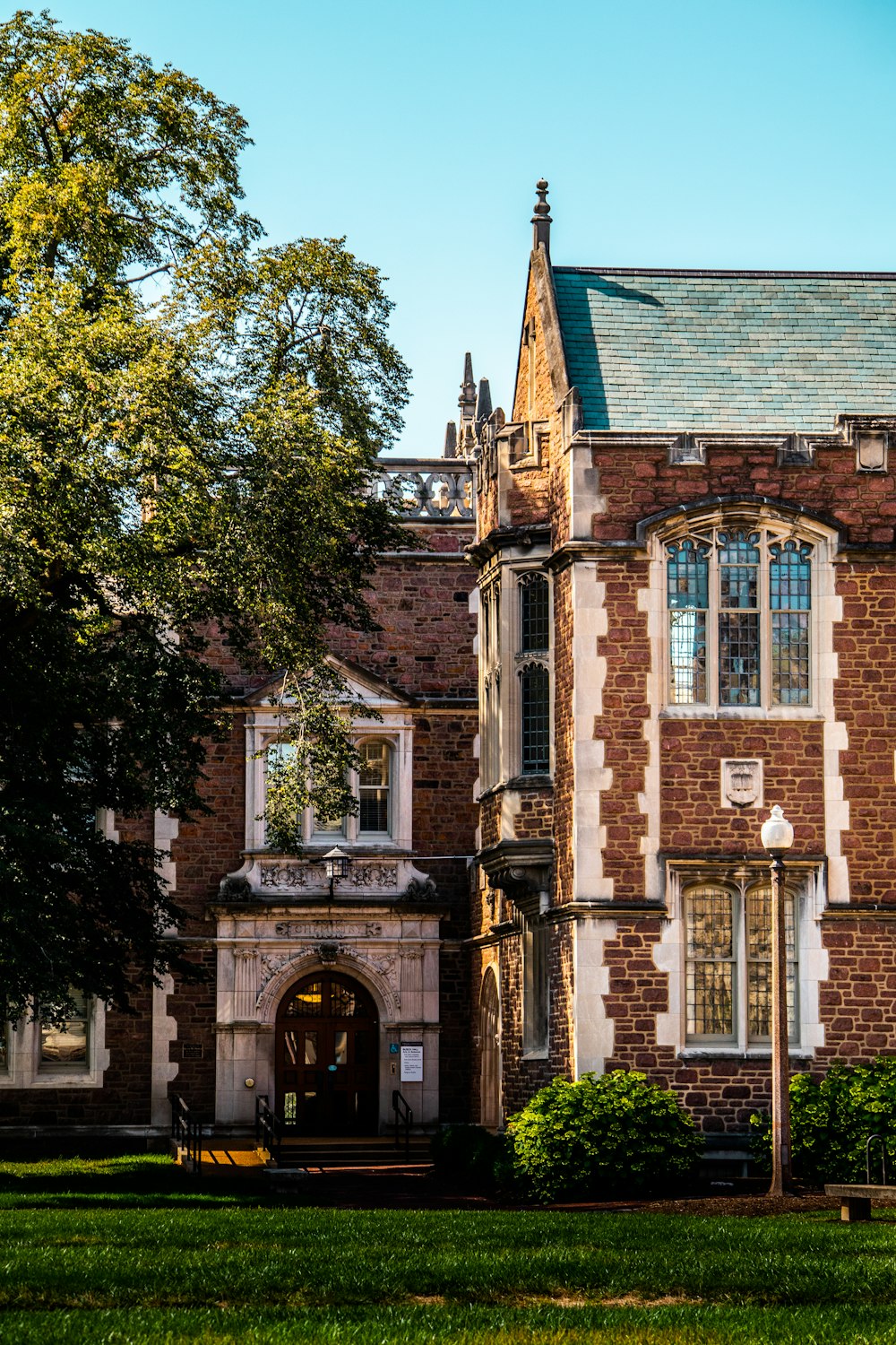 a brick building with a green lawn