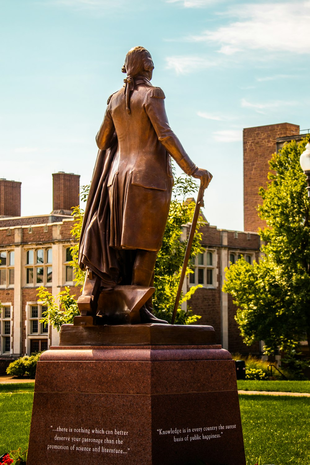 a statue of a person holding a ball