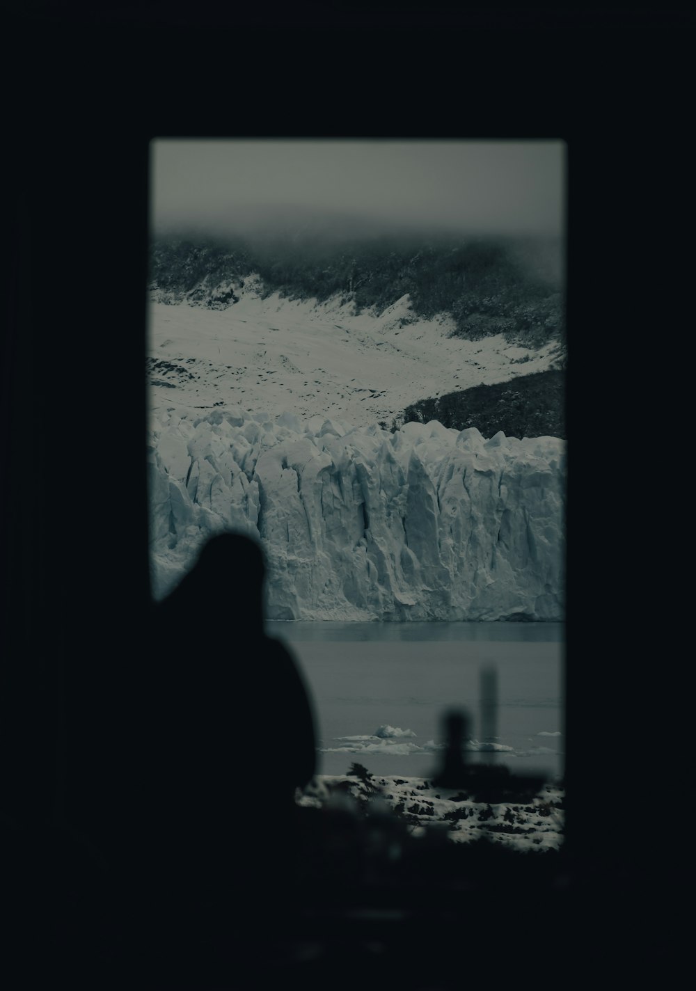 a person looking at a large waterfall