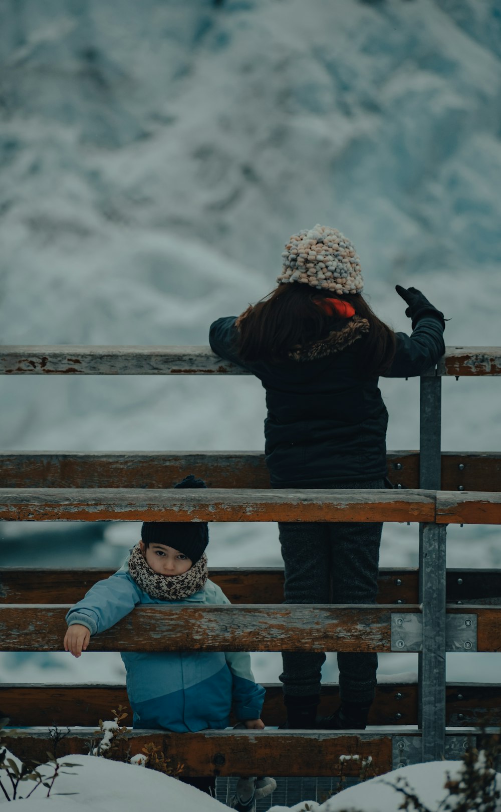 a person and a child on a bridge over a body of water