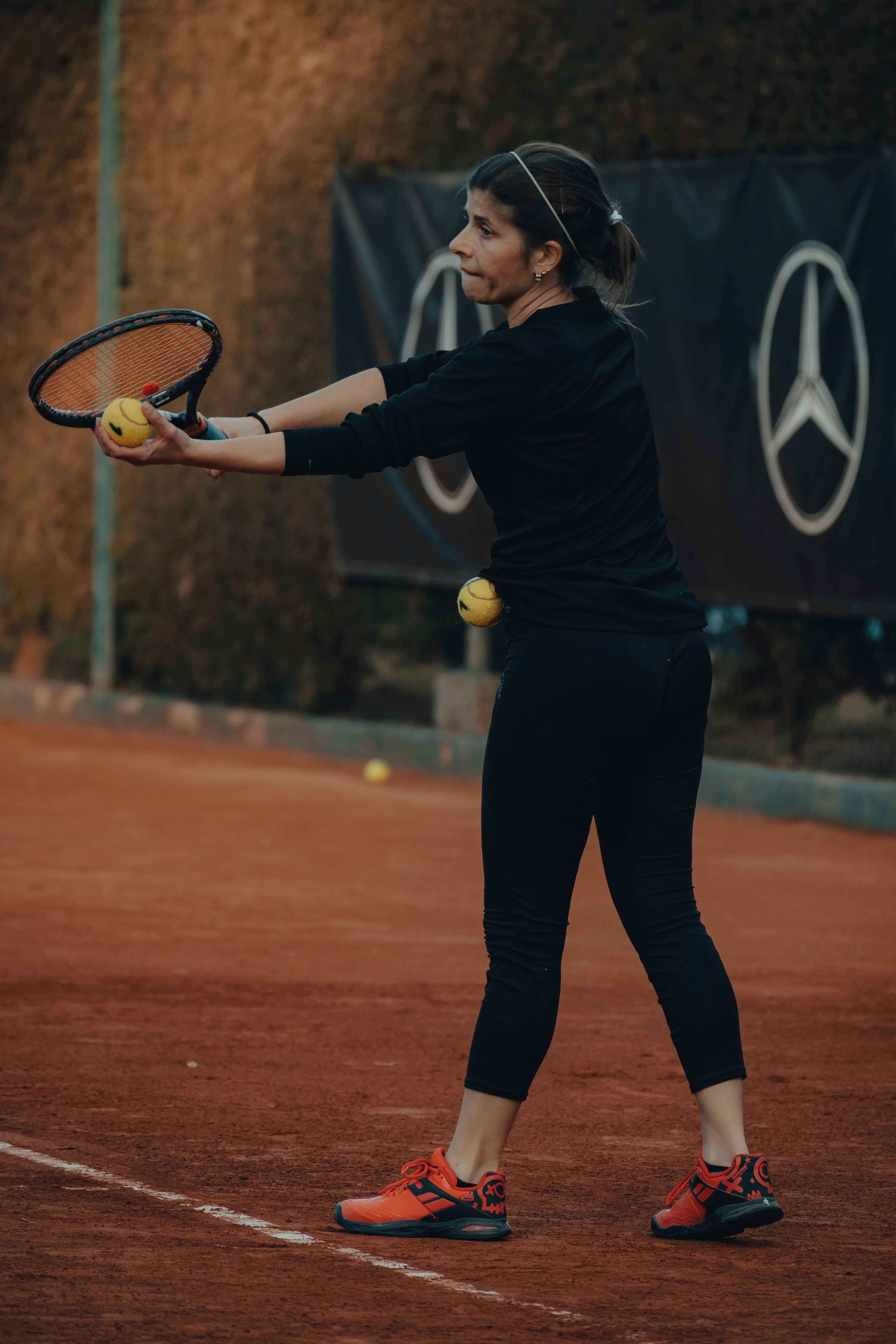 a person hitting a ball with a tennis racket