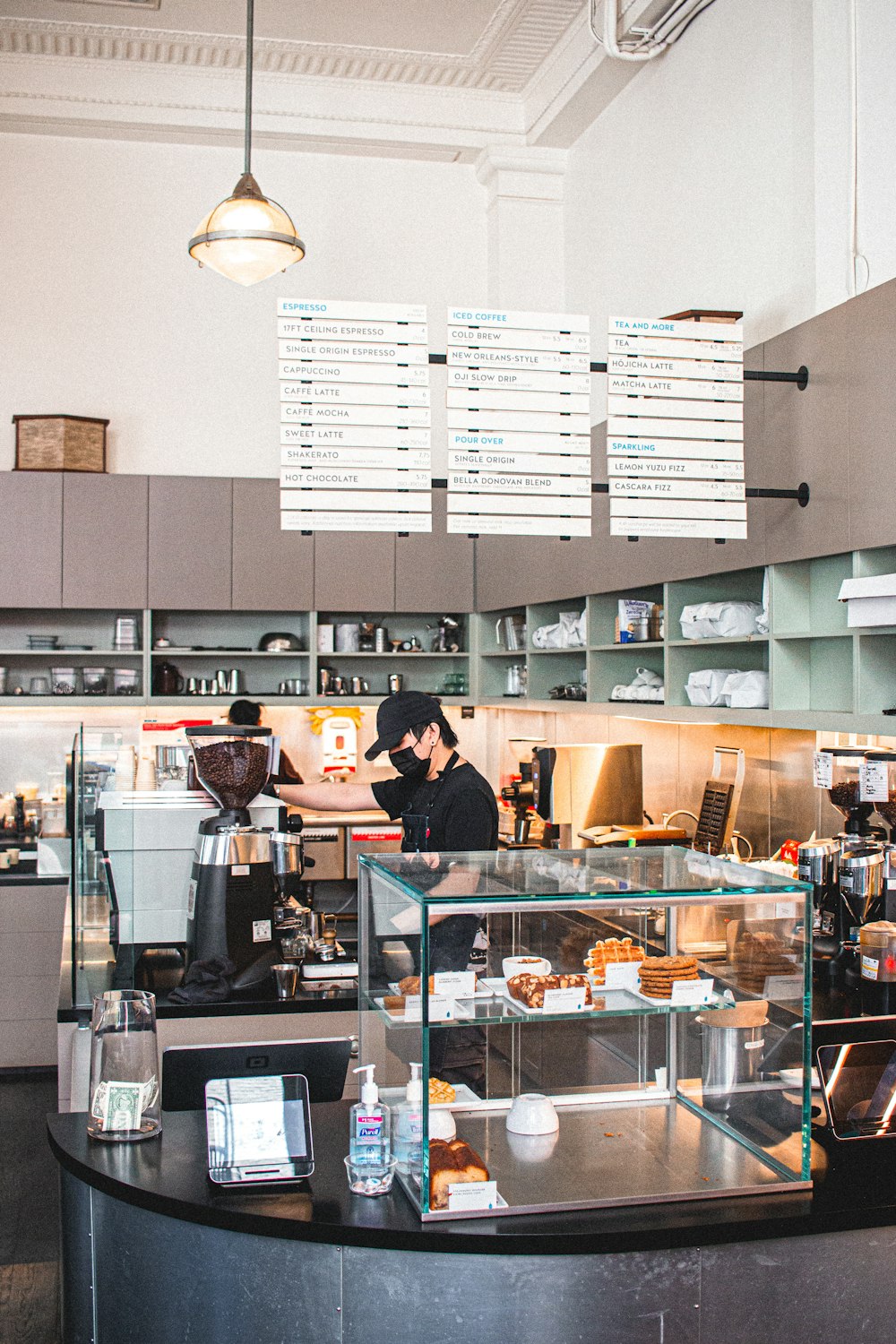 a person behind a counter with food