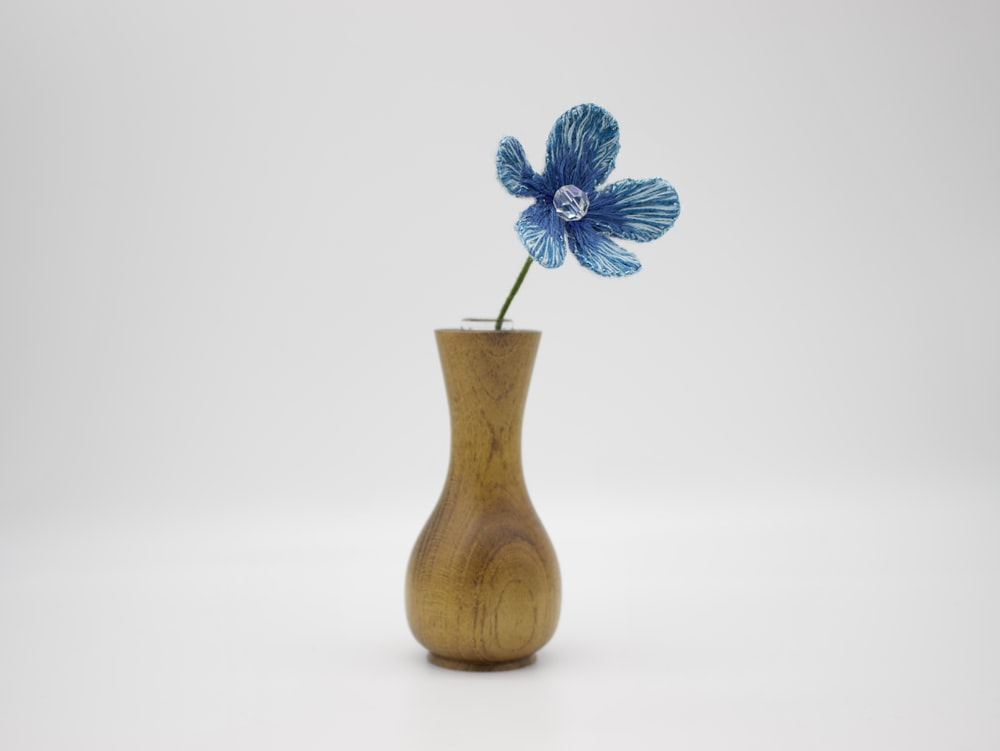 a blue flower in a vase