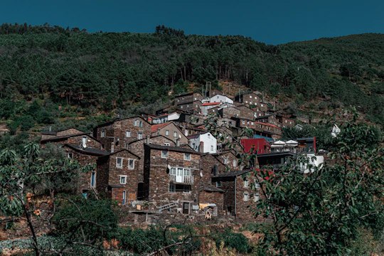 Artisans carefully restoring a traditional stone house in a Corsican village.