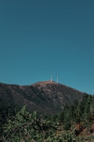 Construction crew installing wind turbines on tribal land under a clear blue sky.