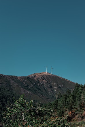 Construction crew installing wind turbines on tribal land under a clear blue sky.