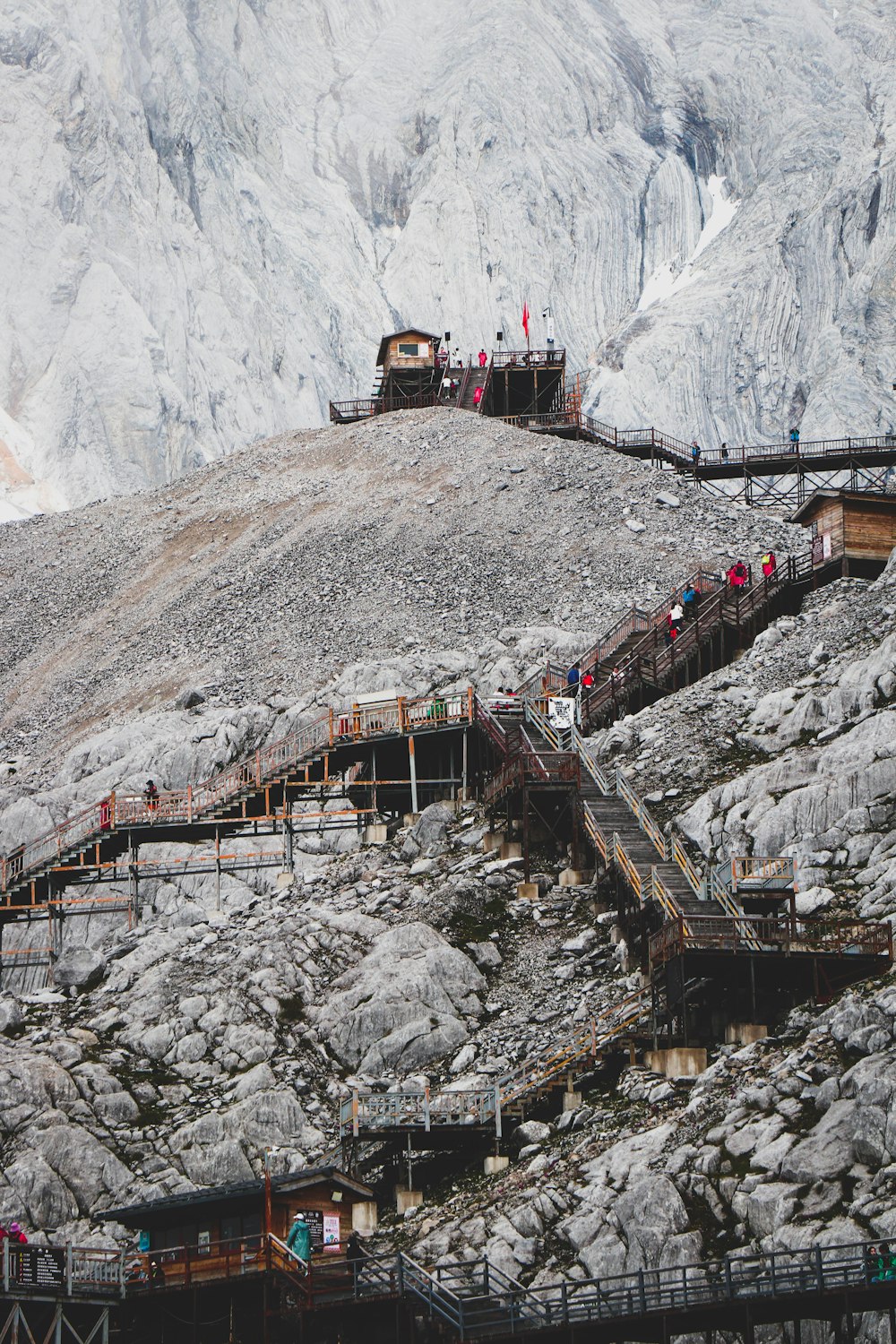 a group of people on a bridge over a river