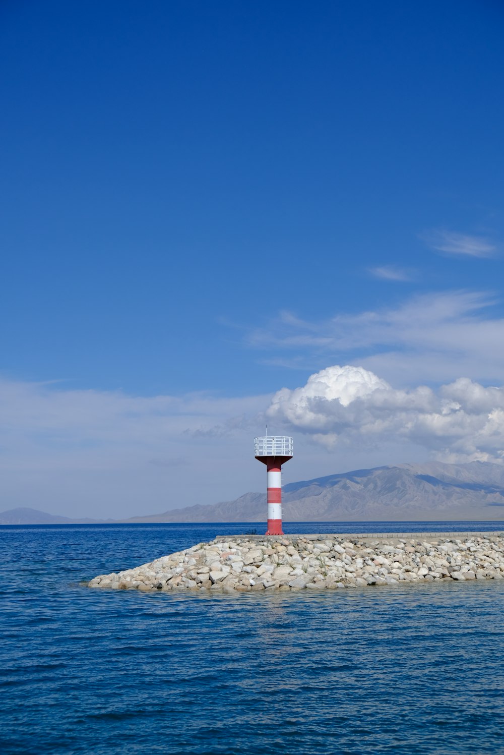 a lighthouse on a rocky island