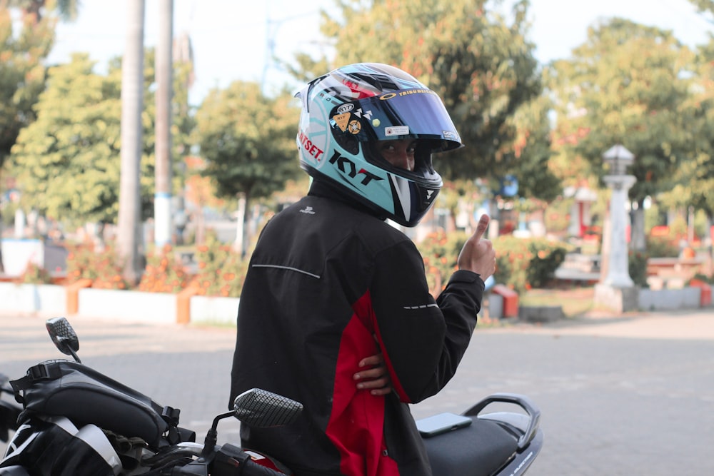 a man wearing a helmet and holding a red object