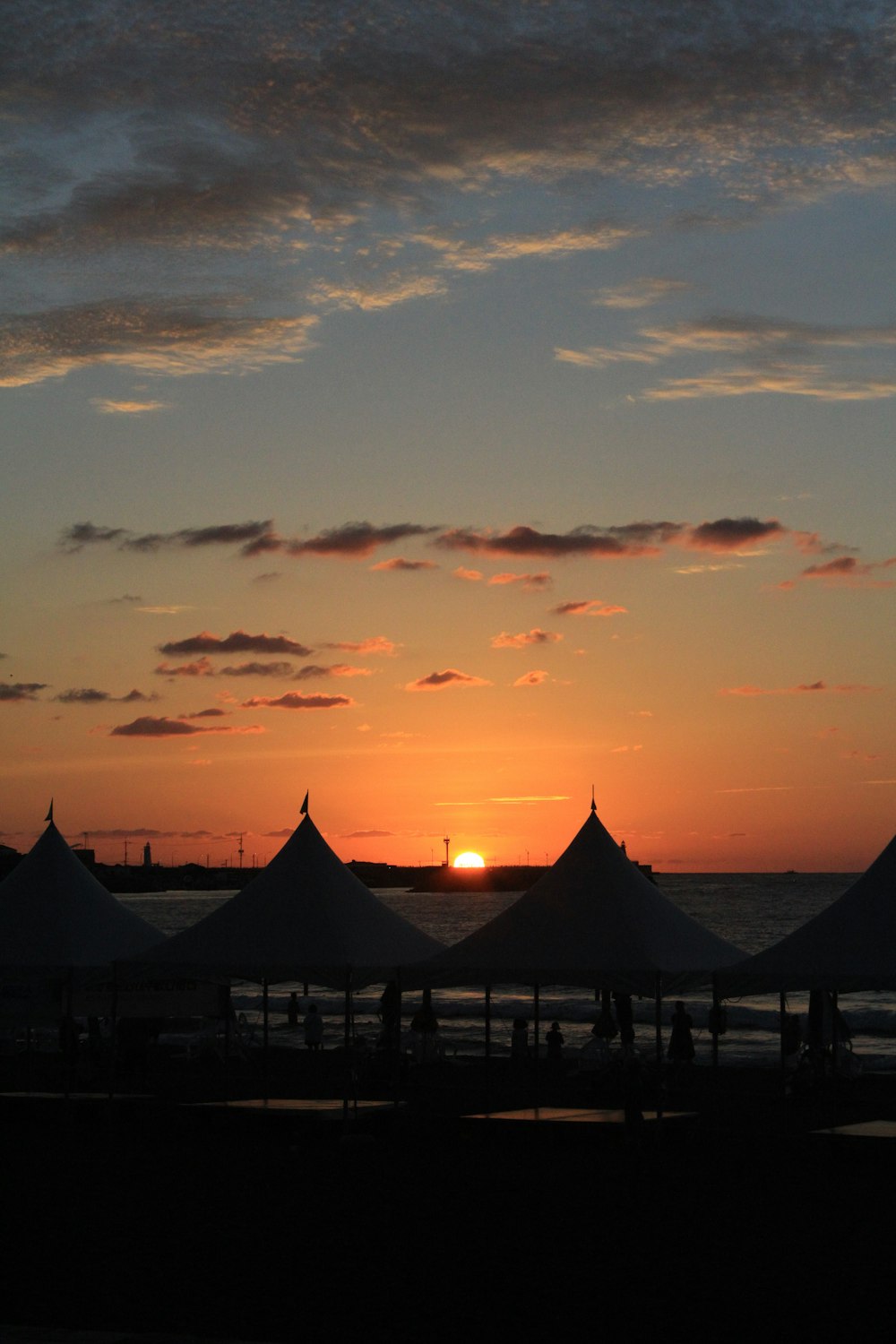 a group of tents at sunset