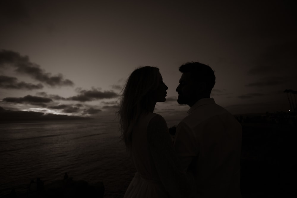 a man and woman standing on a beach