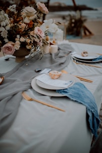a table with plates and flowers