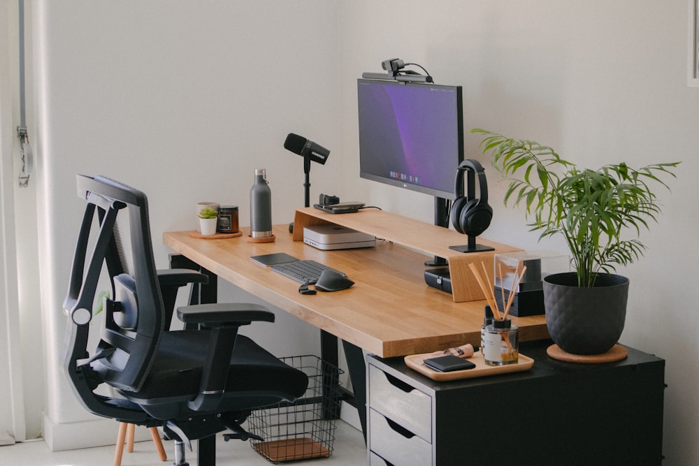 a desk with a computer and a chair