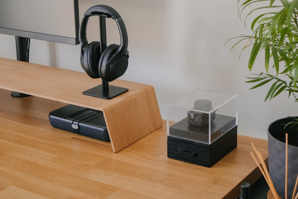 a black and silver object on a wooden surface