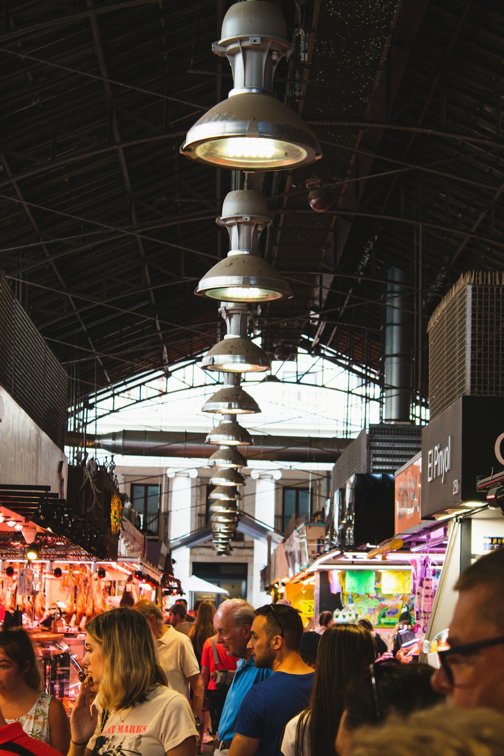 uma multidão de pessoas em uma grande sala com um grande lustre