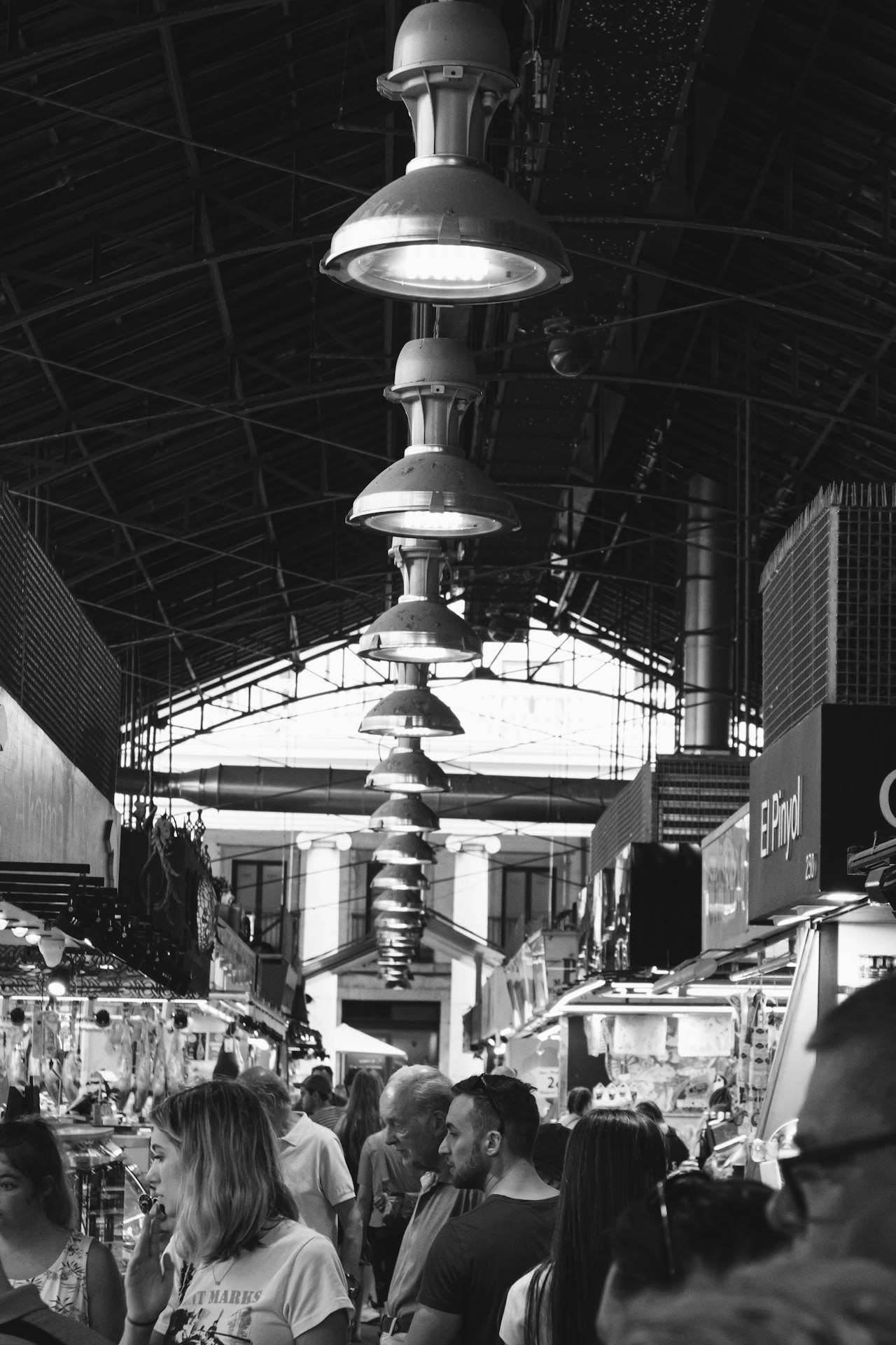 La boqueria crowd of people in a large room with a large chandelier