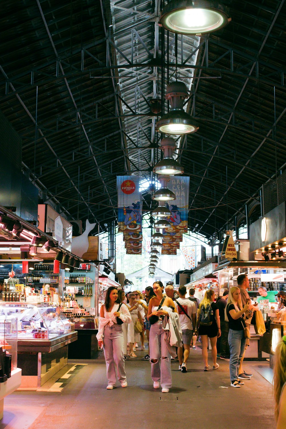 a group of people in a large room with a ceiling of lights