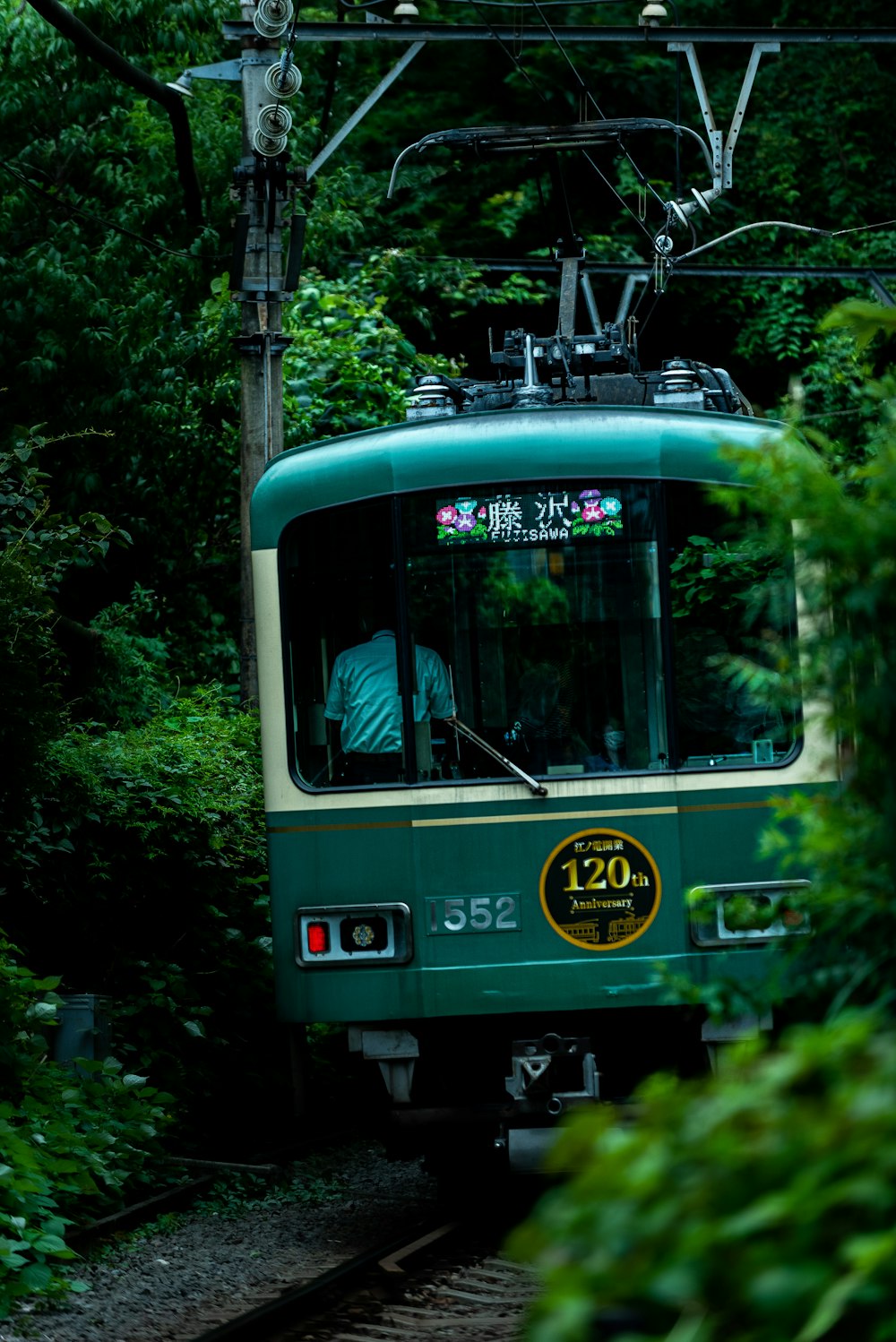 a green train on the tracks